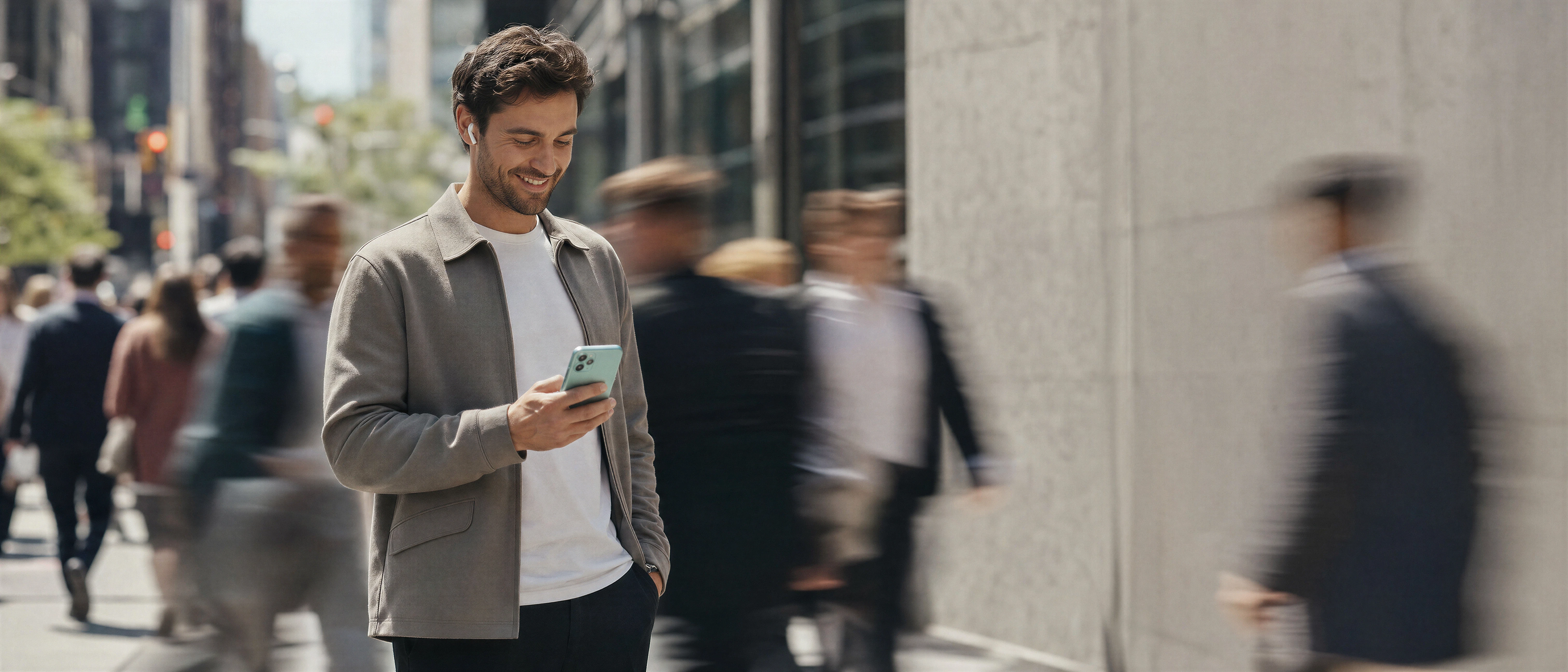 A man on a busy street using an enriched call, AirPods in